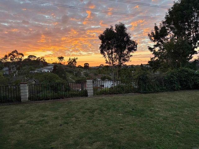 a front view of house with a garden and patio