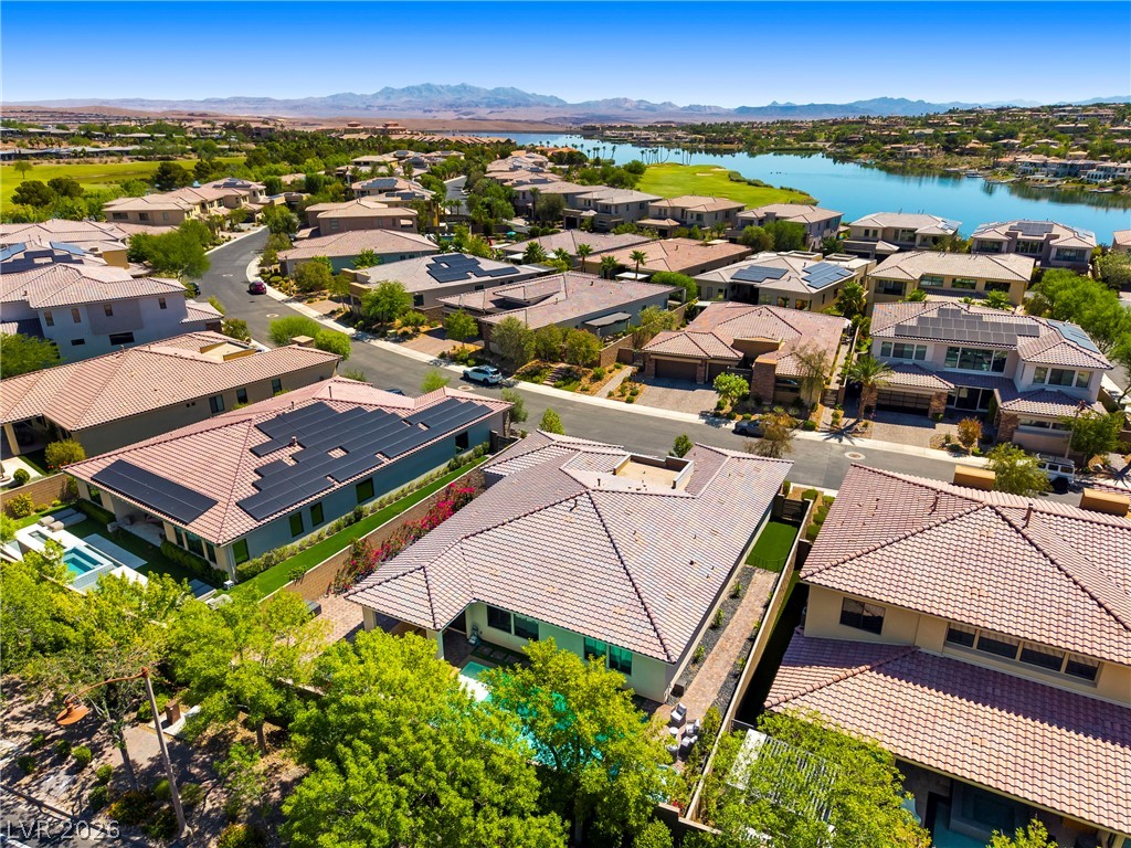 45 Garibaldi Way Henderson, NV 89011 - Photo 48 of 74 An aerial perspective reveals a community nestled around a tranquil lake, offering scenic views.