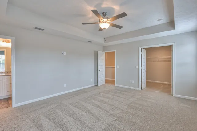an empty room with closet and fan