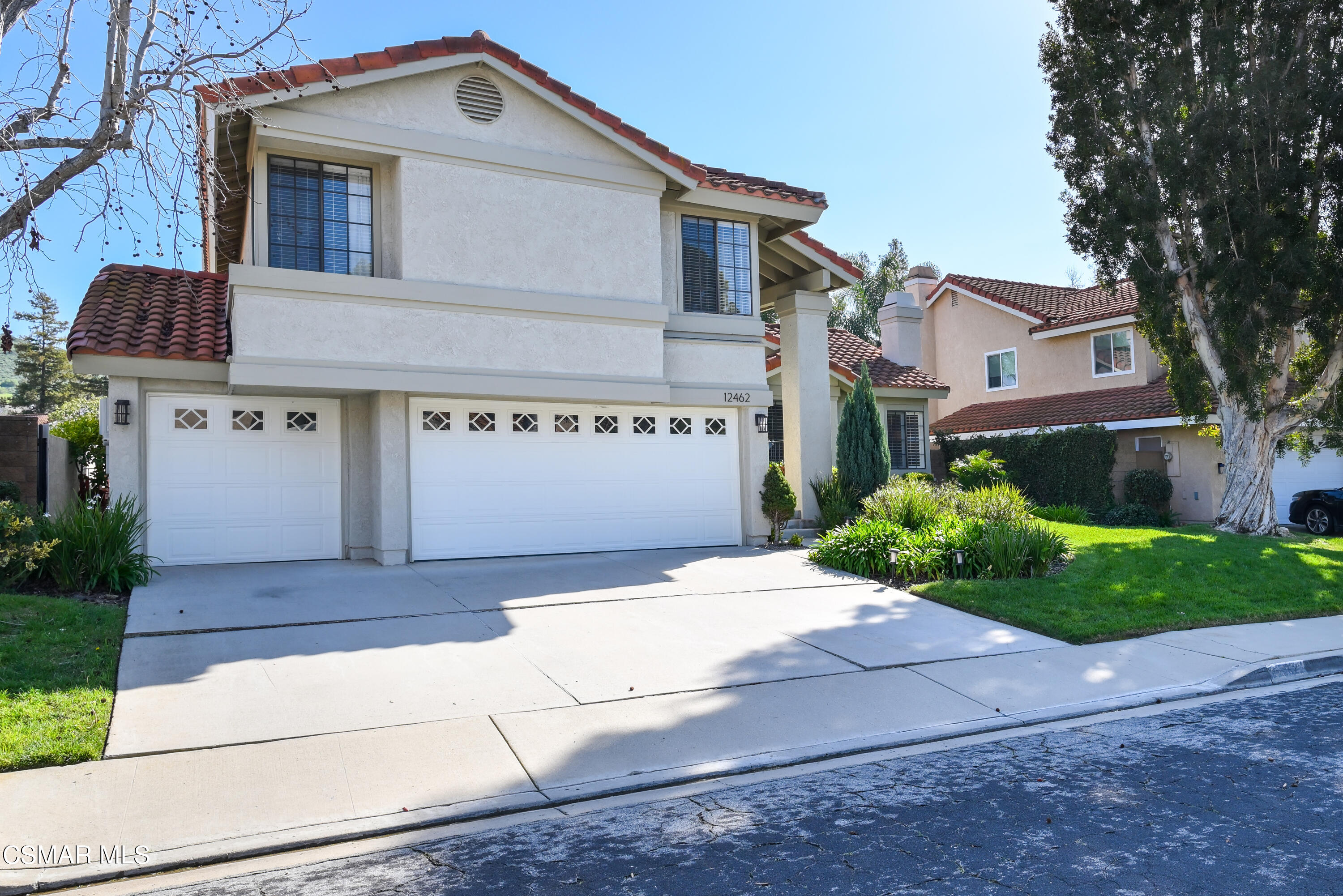 12462 Spring Creek Road Moorpark, CA 93021 - Photo 3 of 57 a front view of a house with a yard and garage