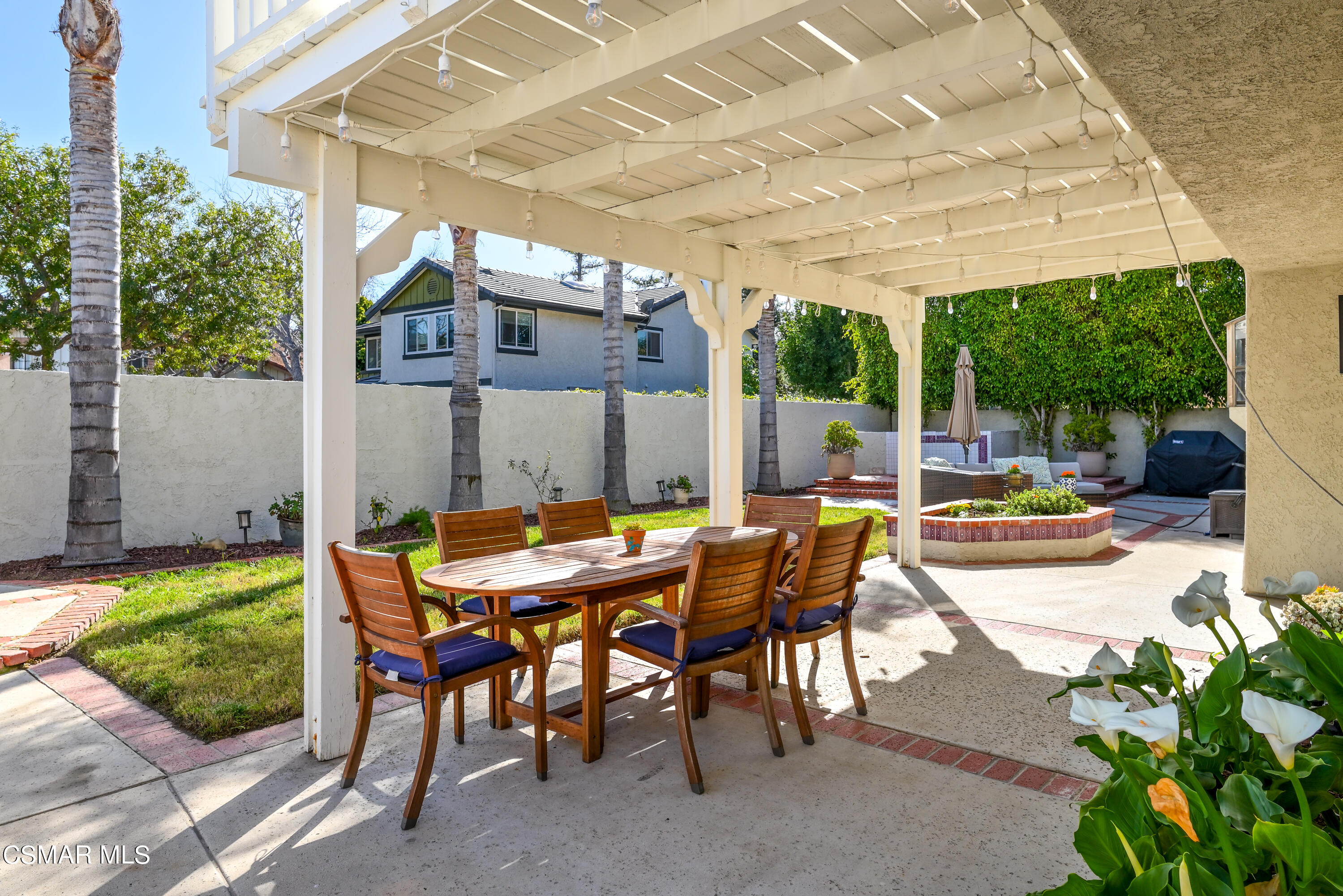 12462 Spring Creek Road Moorpark, CA 93021 - Photo 4 of 57 a view of a patio with a table chairs and a backyard