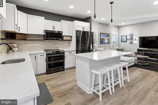 a kitchen that has a lot of counter space and wooden floor