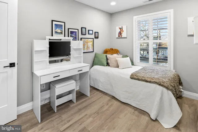 a bedroom with furniture and a flat screen tv