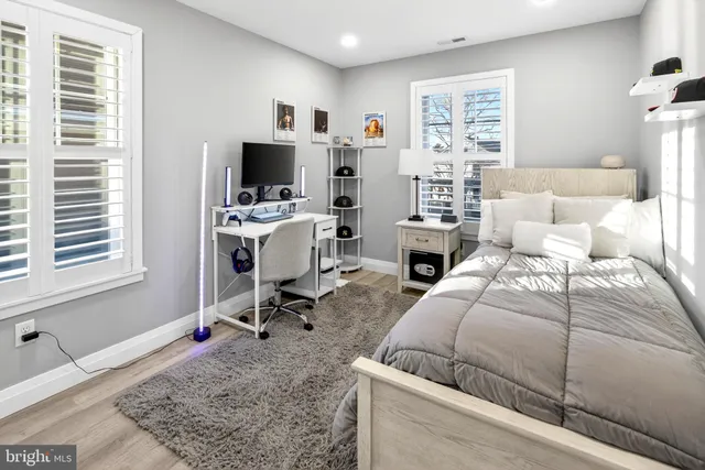 a bed room with a bed and a chair