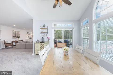 a view of a dining room with furniture wooden floor and chandelier