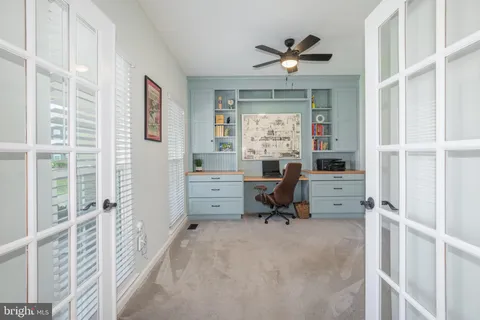 a bedroom with a bed a dresser and a television