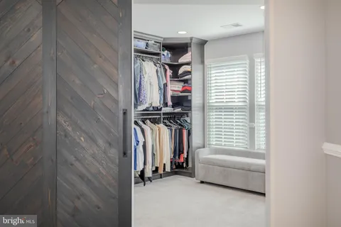 a bedroom with a bed and glass windows