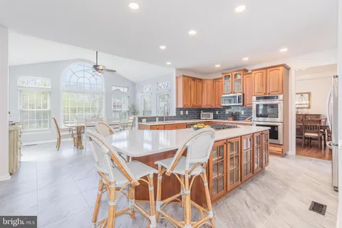 a kitchen with stainless steel appliances granite countertop a sink and cabinets
