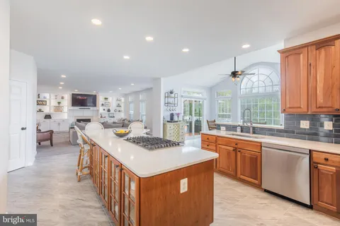 a dining room with furniture a chandelier and wooden floor