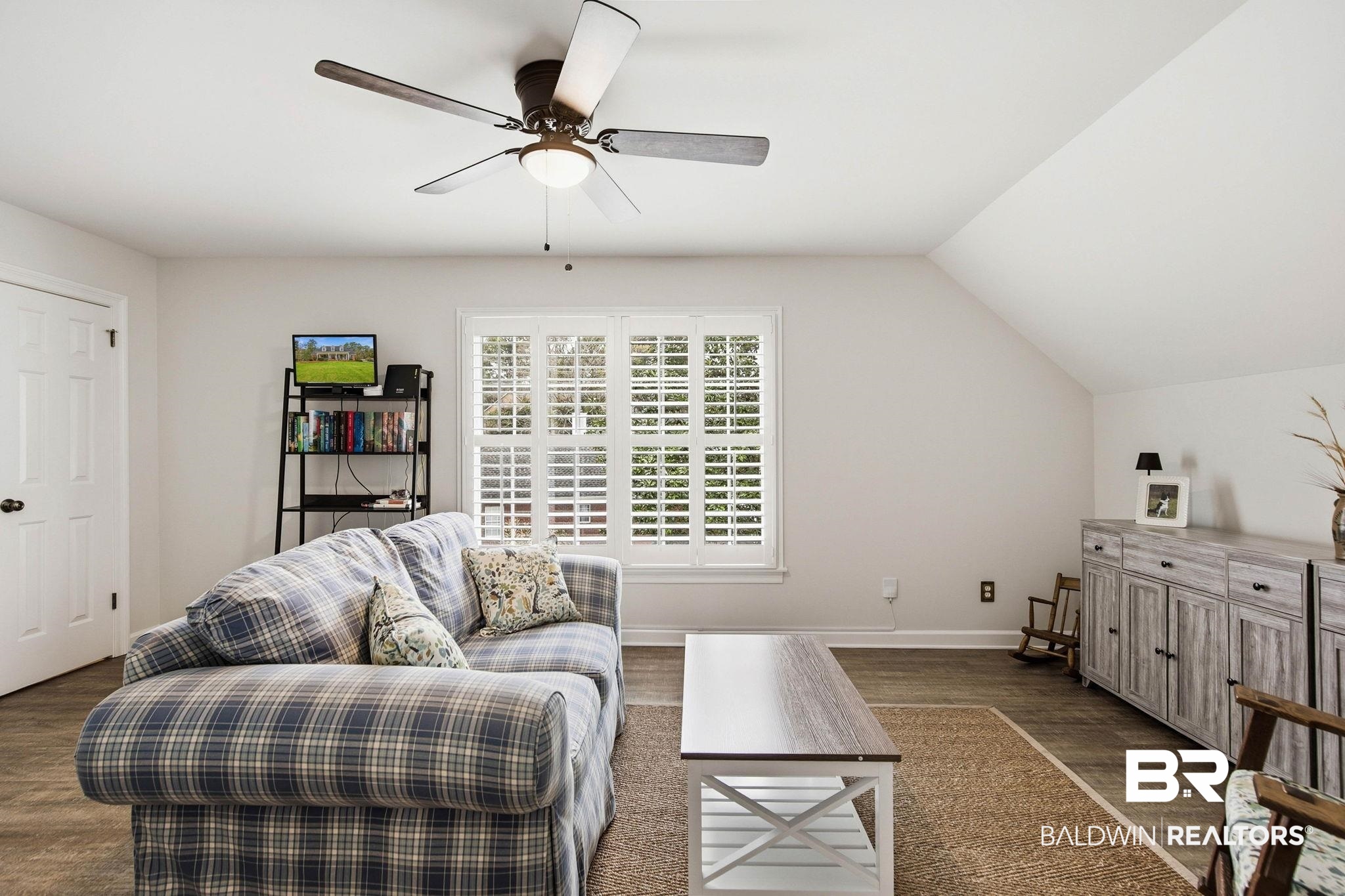 31515 Rhett Drive Spanish Fort, AL 36527 - Photo 58 of 100 Bedroom 5 is being used as a sitting room. The room measures 14' 3" x 19' 4" and has plantation shutters, LVP flooring, a a walk in closet, and an additional closet for storage and has a separate entry to the garage and outside from the second floor.