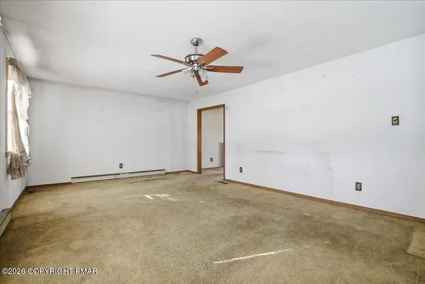 a view of an empty room with a window