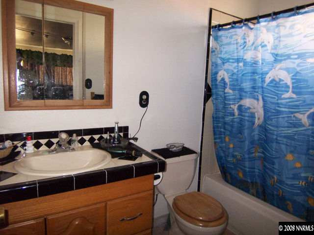 1620 Trainer Way Reno, NV 89512 - Photo 7 of 9 a bathroom with a sink a toilet and shower