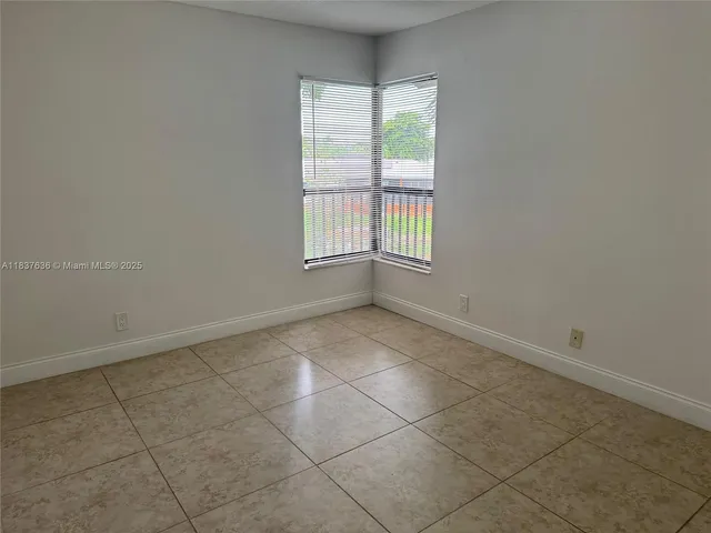 a view of a livingroom with a ceiling fan and window