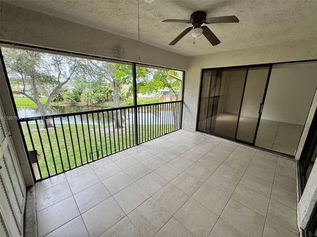 a view of a livingroom with a ceiling fan and window