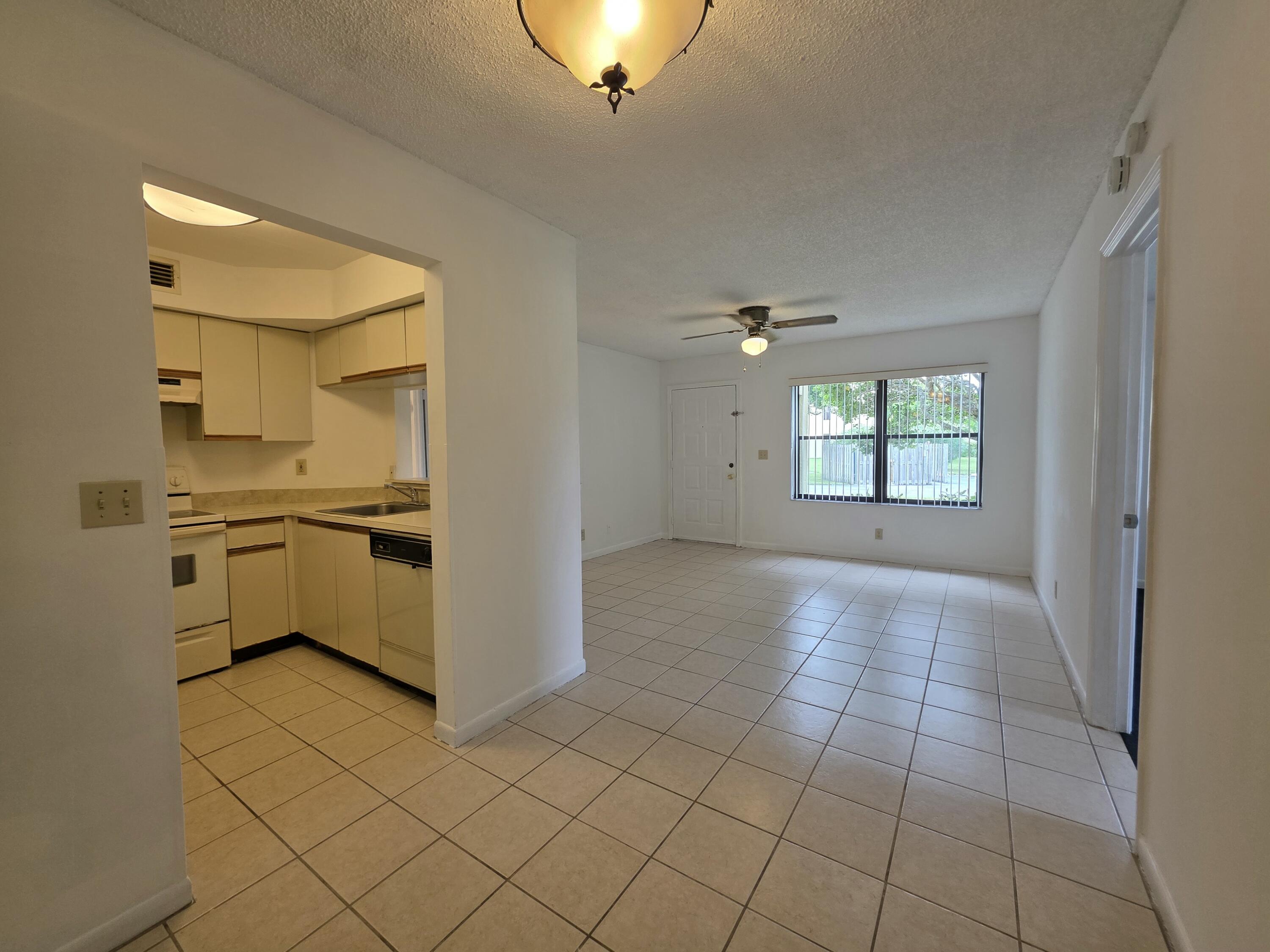 4709 Lucerne Lakes Boulevard East, Unit 101 Lake Worth, FL 33467 - Photo 5 of 18 Living Room and Kitchen