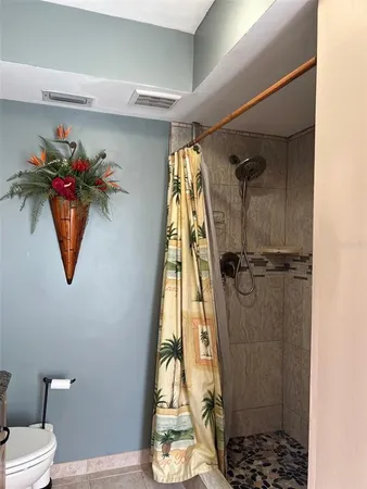 a bathroom with a toilet and a shower