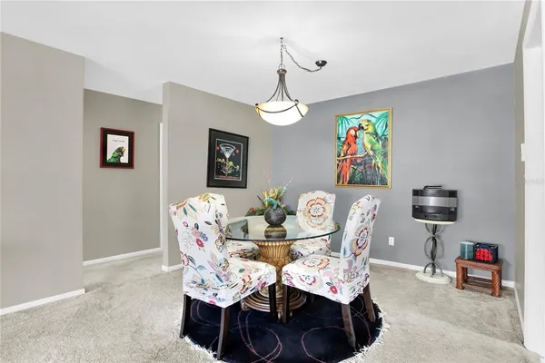 a dining room with furniture a chandelier and window