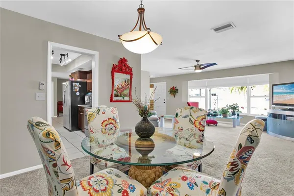 a dining room with furniture and wooden floor