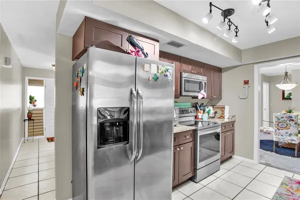 a kitchen with stainless steel appliances granite countertop a refrigerator and a sink