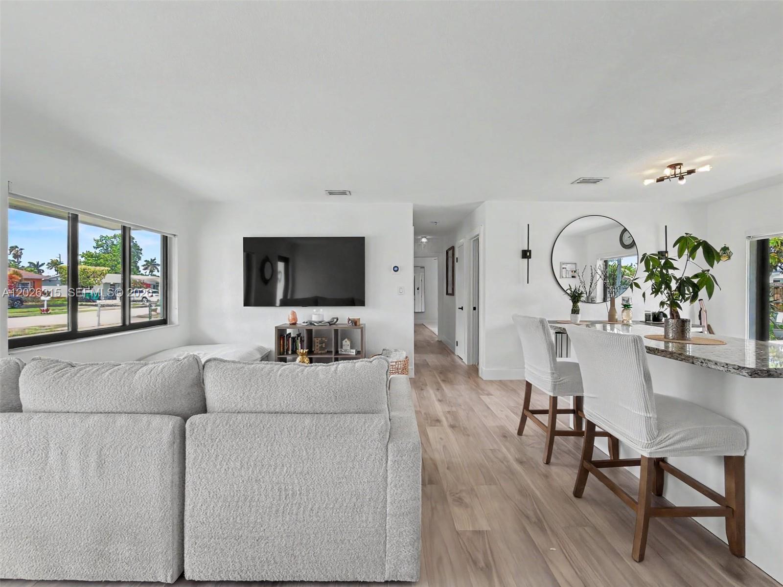 10762 Southwest 145th Street Miami, FL 33176 - Photo 22 of 28 a living room with furniture a flat screen tv and a large window