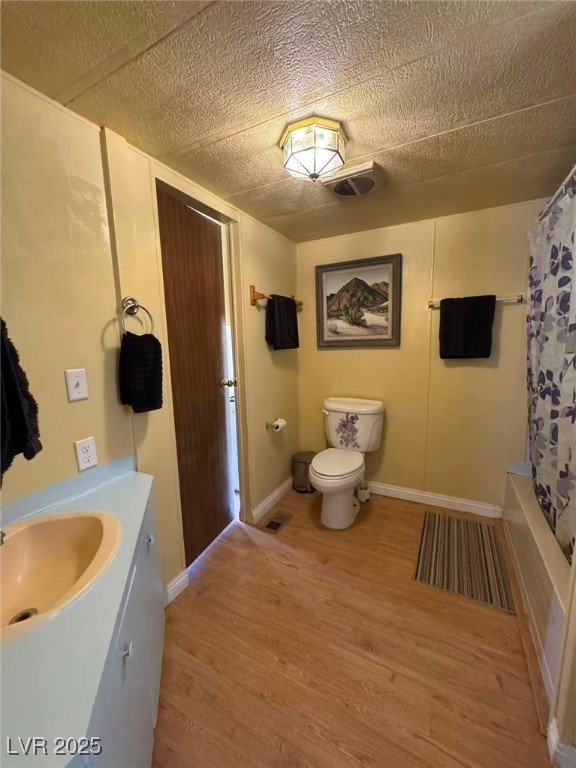 551 Piltz Road Pahrump, NV 89060 - Photo 15 of 22 Bathroom with vanity, light wood finished floors, shower / tub combo with curtain, and a textured ceiling