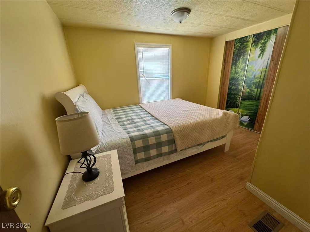 551 Piltz Road Pahrump, NV 89060 - Photo 17 of 22 Bedroom with wood finished floors
