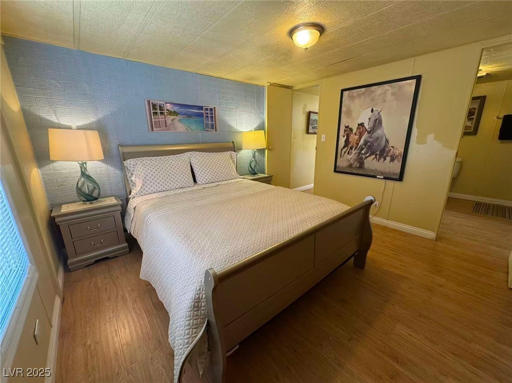 551 Piltz Road Pahrump, NV 89060 - Photo 10 of 22 Bedroom featuring wood finished floors and a textured ceiling