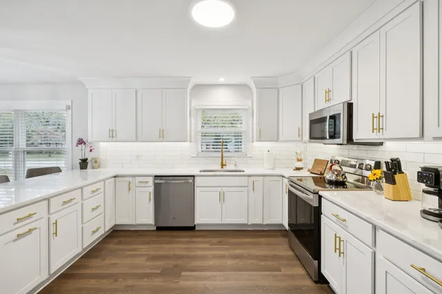 a kitchen with sink cabinets and microwave