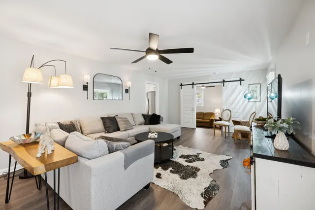 a living room with furniture and wooden floor