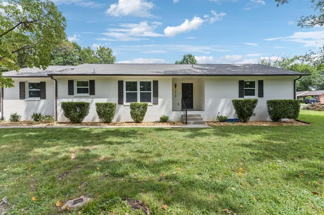 a front view of house with yard and outdoor seating
