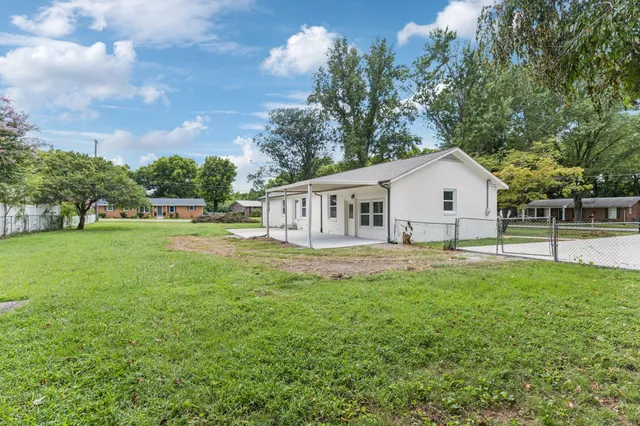 a view of house with backyard