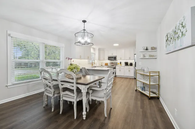 a view of a dining room with furniture window and wooden floor