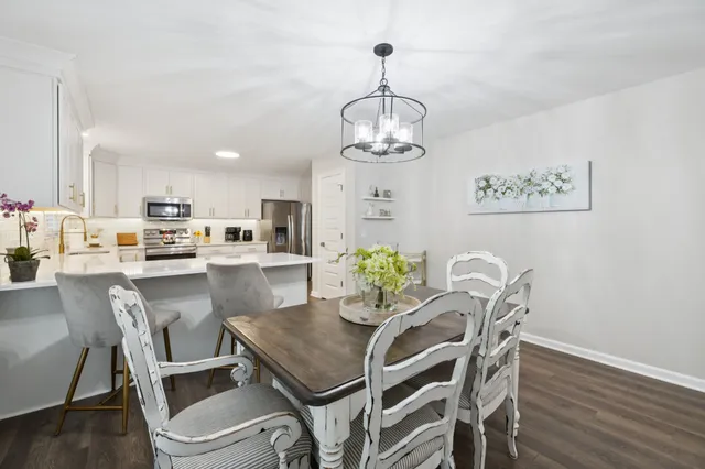 a view of a dining room with furniture wooden floor and chandelier
