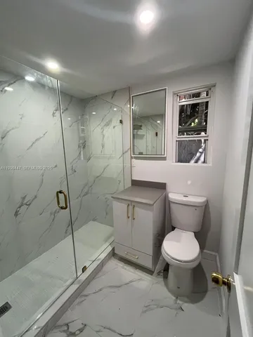 a bathroom with a toilet sink and shower