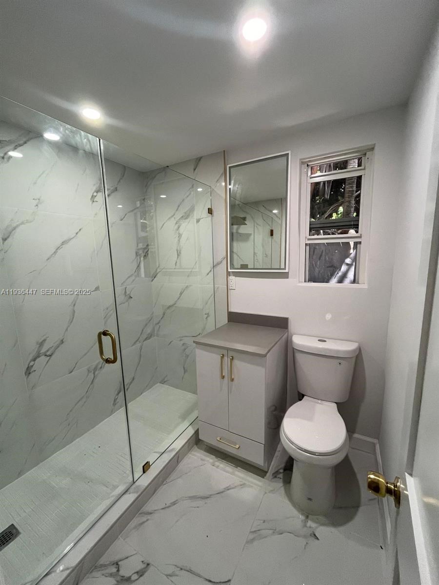 610 Southwest 13th Avenue, Unit 4 Miami, FL 33135 - Photo 1 of 10 a bathroom with a toilet sink and shower