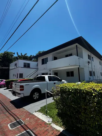 a front view of a house with parking space