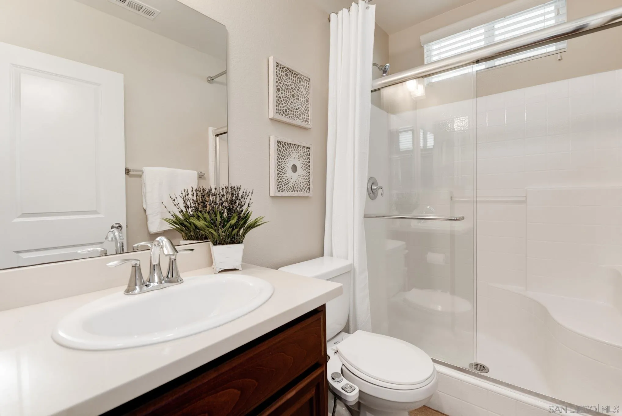 1767 Ragtime Way Oceanside, CA 92054 - Photo 15 of 28 a bathroom with a sink a toilet and shower