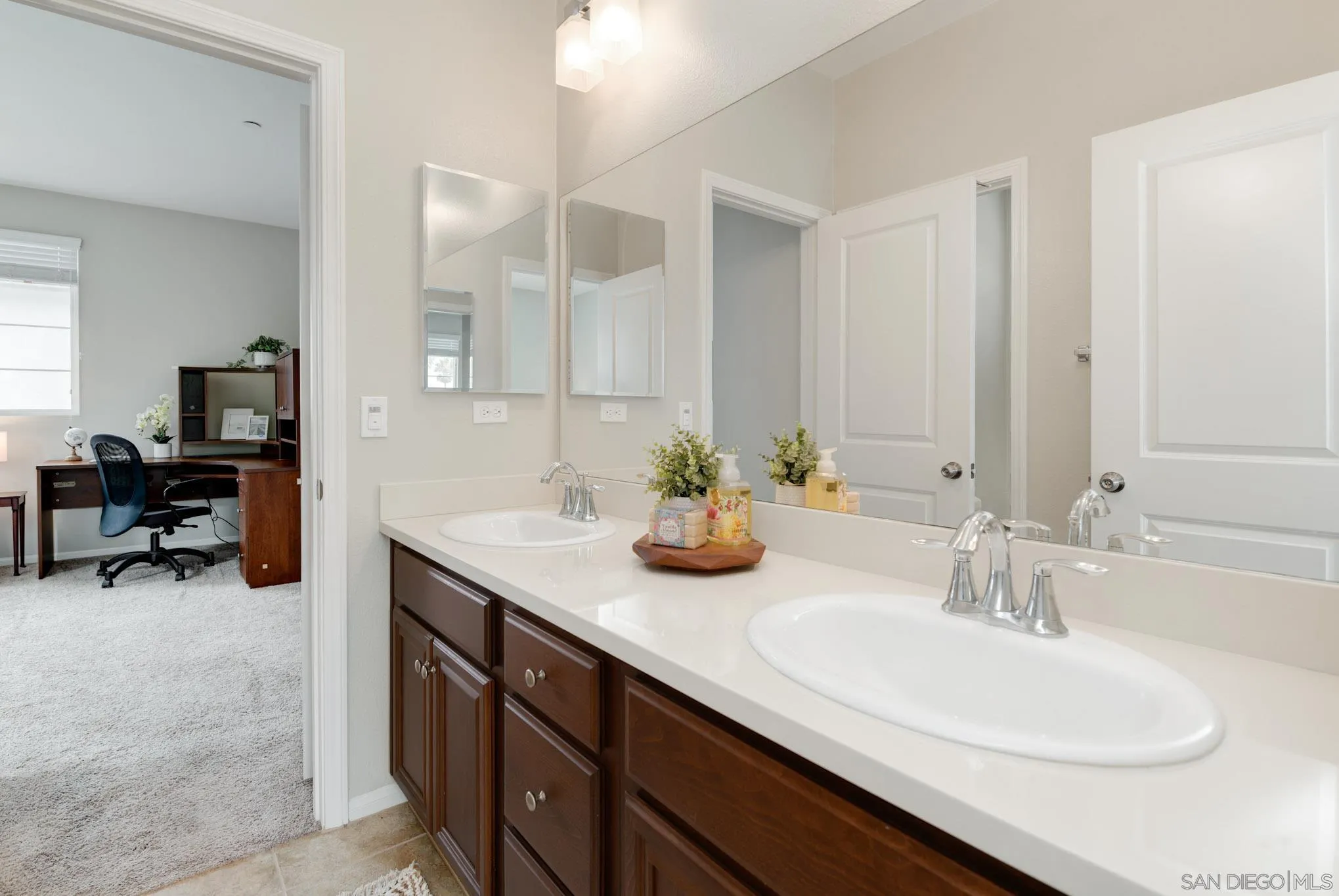 1767 Ragtime Way Oceanside, CA 92054 - Photo 17 of 28 a en suite bathroom with double sink and a mirror