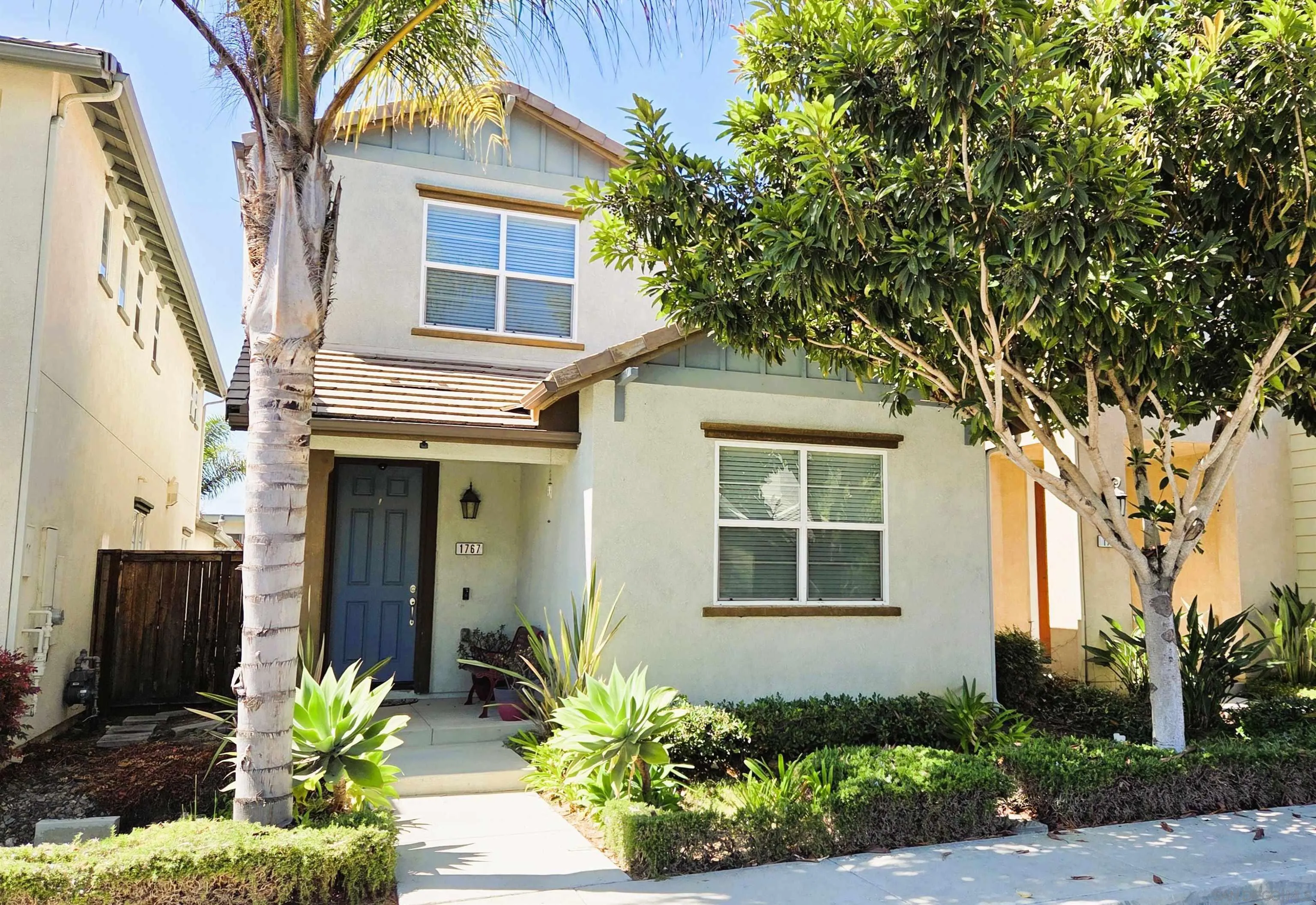 1767 Ragtime Way Oceanside, CA 92054 - Photo 2 of 28 a front view of a house with a garden