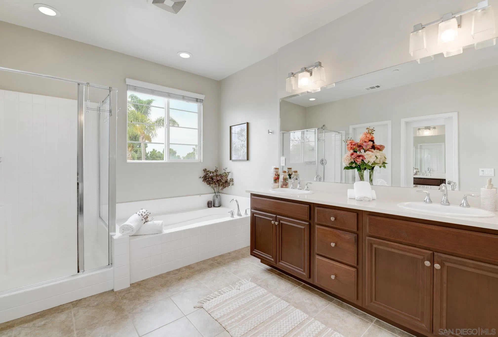 1767 Ragtime Way Oceanside, CA 92054 - Photo 21 of 28 a spacious bathroom with a tub sink double vanity and mirror