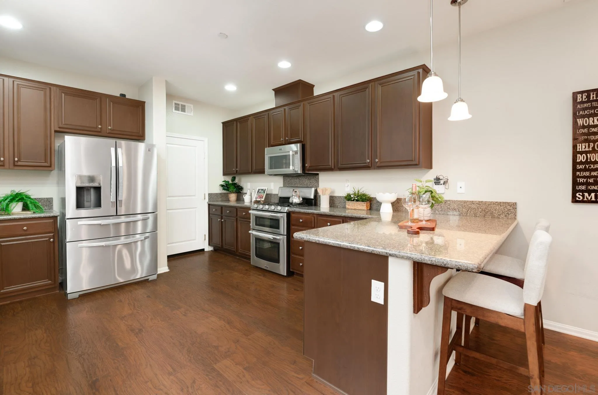 1767 Ragtime Way Oceanside, CA 92054 - Photo 7 of 28 a kitchen with stainless steel appliances a refrigerator sink and microwave