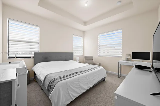 a bedroom with a bed and a desk