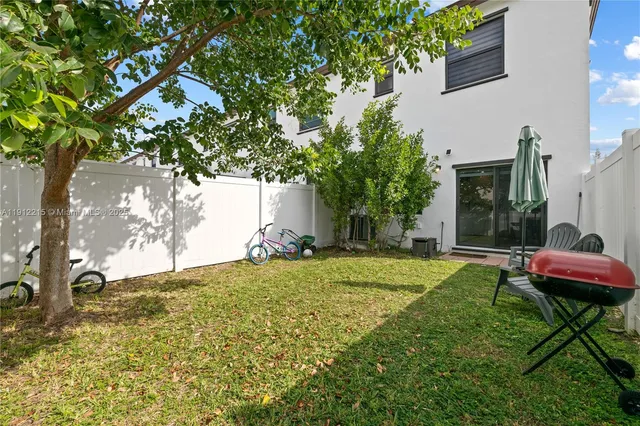 a backyard of a house with table and chairs