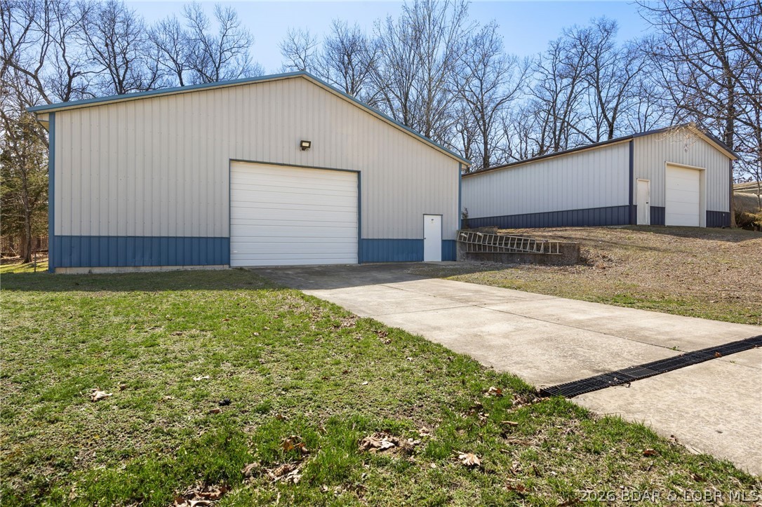 1386 Nichols Road Osage Beach, MO 65065 - Photo 49 of 62 Large shop with poured concrete driveway to the ov