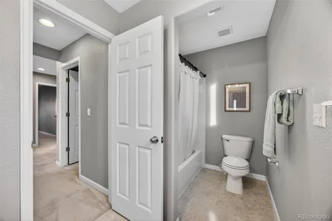 a bathroom with a toilet sink and shower