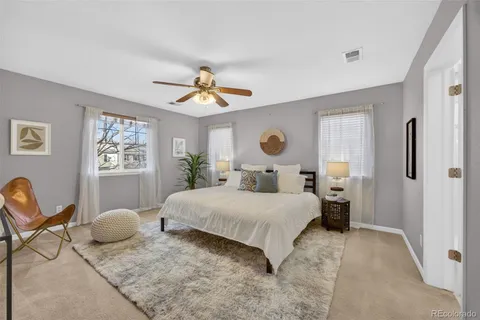 a bedroom with a bed and painting on the wall