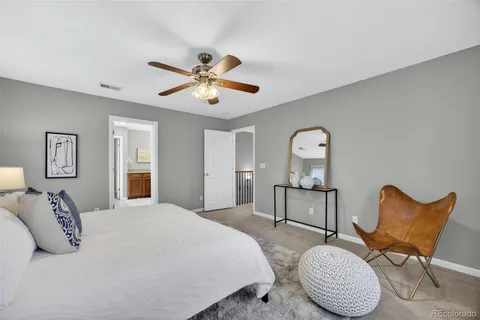 a bedroom with a bed chair and dresser