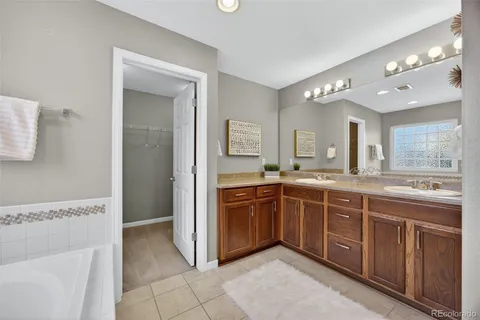 a spacious bathroom with a granite countertop sink and a mirror