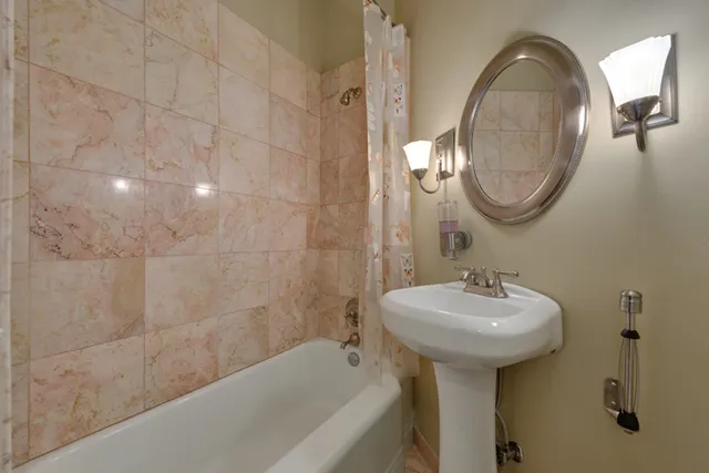 a bathroom with a sink a mirror and a bathtub