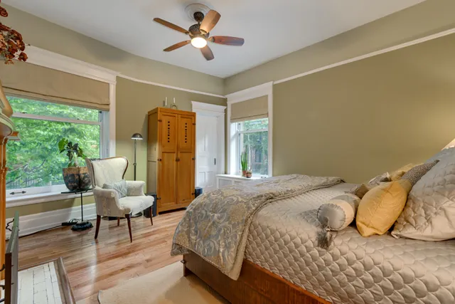a bedroom with a bed and wooden floor
